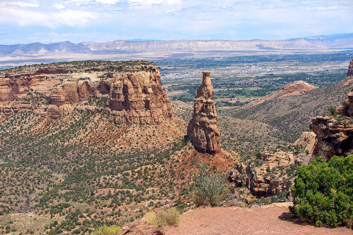 Independence Monument rising above the red sandstone canyons of Colorado National Monument